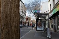 a bus stop on a city street with a tree at We Love Paris - Private Apartment in Vitry-sur-Seine