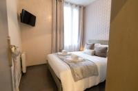 a bedroom with a bed with towels on it at We Love Paris - Private Apartment in Vitry-sur-Seine
