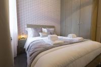a bedroom with a large bed with towels on it at We Love Paris - Private Apartment in Vitry-sur-Seine