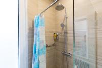 a shower with a blue shower curtain in a bathroom at We Love Paris - Private Apartment in Vitry-sur-Seine
