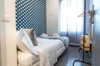 a bedroom with a bed with a blue and white wall at We Love Paris - Private Apartment in Vitry-sur-Seine