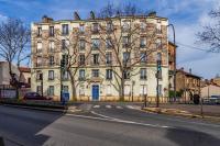 a large stone building on a city street with a road at We Love Paris - Private Apartment in Vitry-sur-Seine