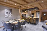 a dining room and kitchen with a table and chairs at La cabane luxury apartment in the heart of the village in La Grave