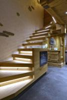 a staircase in a house with wooden floors at La cabane luxury apartment in the heart of the village in La Grave