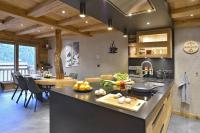 a kitchen and living room with a counter and a table at La cabane luxury apartment in the heart of the village in La Grave