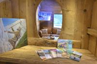 a room in a log cabin with magazines on a table at La cabane luxury apartment in the heart of the village in La Grave