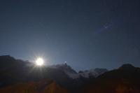 a starry night sky with the sun over the mountains at La cabane luxury apartment in the heart of the village in La Grave