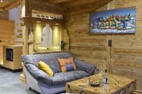 a living room with a couch and a table at La cabane luxury apartment in the heart of the village in La Grave