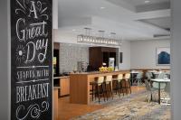 a restaurant with a bar with a chalkboard on the wall at TownePlace Suites by Marriott Cheyenne Southwest/Downtown Area in Cheyenne