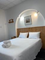 a bedroom with a bed with two towels on it at Hôtel Le National in Saint-Étienne