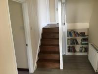 a stairway with a bookcase next to it at Captivating 8-Bed House in Porthleven in Porthleven