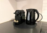 a black coffee maker sitting on top of a counter at Le Charme D&#39;Antan in Évreux