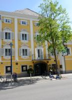 a yellow building with a tree in front of it at Hotel Gösser Bräu in Wels