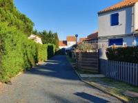 an empty street with a house and a fence at Maison La Faute-sur-Mer, 2 pièces, 4 personnes - FR-1-476-184 in La Faute-sur-Mer