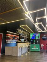 a bar in a room with stools and a tv at Citadines Sukhumvit 11 Bangkok in Bangkok