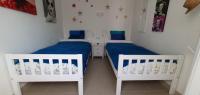 A bed or beds in a room at Las Golondrinas - RISSAGA