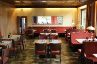 a dining room with tables and chairs and a unintention at Landgasthof 'Zur Quelle' in Wächtersbach