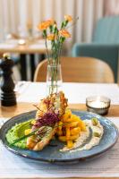 a plate of food with fish and fries on a table at NOVY Hotel in Zielona Góra