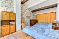 a bedroom with three beds and a teddy bear at Le Grappillon in Fitou