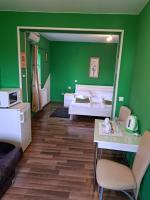 a green bedroom with a bed and a mirror at Rooms Modrušan in Slunj