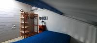 - une chambre avec un lit bleu et un placard dans l&#39;établissement Maison de la plage, à Valras-Plage
