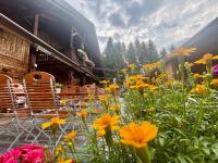 a garden with flowers in front of a building at Sweet Cherry - Boutique &amp; Guesthouse Tyrol in Innsbruck