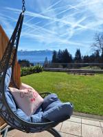 a hammock chair with a view of a park at Sweet Cherry - Boutique &amp; Guesthouse Tyrol in Innsbruck