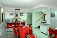 a dining room with a red table and chairs at Hotel Malpensafiera in Bernate Ticino