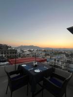 a table and chairs on a balcony with a view at Madri Haveli in Udaipur