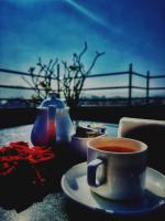 a cup of coffee on a plate on a table at Madri Haveli in Udaipur