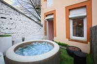 a hot tub in a yard next to a building at LOVE ROOM with jacuzzi and beautiful terrace in Toulouse