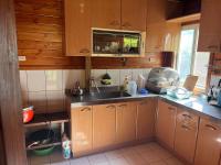 a kitchen with wooden cabinets and a sink at Ji Ji Farm Homestay in Jiji