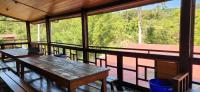 a screened in porch with a table and a laptop on it at Ji Ji Farm Homestay in Jiji