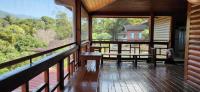 a porch with benches and a view of the forest at Ji Ji Farm Homestay in Jiji