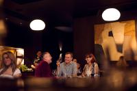 a group of people sitting at a table in a restaurant at Abstract Hotel in Auckland