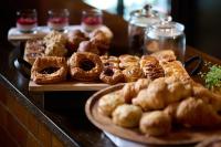a table with a bunch of pastries and pies at Abstract Hotel in Auckland