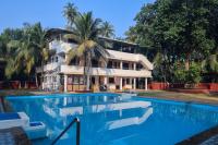 a large swimming pool in front of a house at Vishwas Executive in Malvan