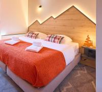 a bedroom with a bed with two towels on it at Hotel Base Camp Lodge - Albertville in Albertville