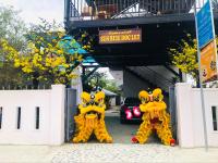 two people in yellow costumes standing in front of a car at Sunrise Dốc Lết in Ninh Hai