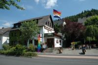 a building with a flag on top of it at Gasthof Holländer Eck in Lennestadt