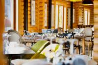 a restaurant with tables and chairs with glasses on them at Wood Hills Hotel & Resort in Mayrūbā