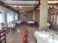 a dining room with white tables and chairs at DIMAL CASTLE in Poshnje