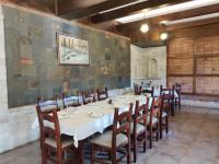 a dining room with a white table and chairs at DIMAL CASTLE in Poshnje