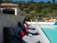 a group of lounge chairs next to a swimming pool at Magnificent Villa in Saint Ambroix with Private Pool in Saint-Ambroix