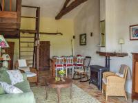 a living room with a couch and a wood stove at Snug cottage in Saint Eutrope De Born with pool in Saint-Eutrope-de-Born