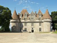 a child is standing in front of a castle at Snug cottage in Saint Eutrope De Born with pool in Saint-Eutrope-de-Born