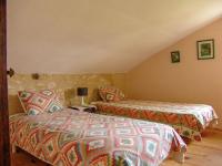 a bedroom with two beds in a attic at Snug cottage in Saint Eutrope De Born with pool in Saint-Eutrope-de-Born