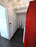 an empty room with a red door and a hallway at Le Verdure YourHostHelper in Bayonne