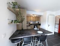 a kitchen with a black counter top and some stools at Le Verdure YourHostHelper in Bayonne