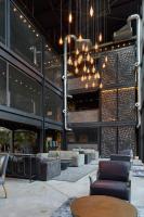 a lobby of a building with couches and tables at Cargo88 Hotel in Lusaka